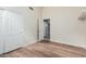 This bedroom offers wood-look floors and a closet for storage and convenience at 4620 E Desert Cactus St, Phoenix, AZ 85032