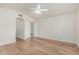 Spacious bedroom with hardwood flooring, light-colored walls, ceiling fan, and closet with sliding doors at 4620 E Desert Cactus St, Phoenix, AZ 85032