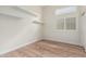 This light and airy bedroom features wood-look floors, modern shelving and a bright window at 4620 E Desert Cactus St, Phoenix, AZ 85032