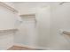 Walk-in closet with white walls, wooden shelving, and wood look floors at 4620 E Desert Cactus St, Phoenix, AZ 85032