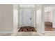 Bright foyer with neutral tile flooring, leading into a spacious living area, with the front door at 4620 E Desert Cactus St, Phoenix, AZ 85032