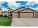 Charming single-story home with a three car garage, tile roof and manicured front lawn at 4620 E Desert Cactus St, Phoenix, AZ 85032