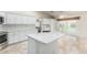 Spacious kitchen with white cabinets, marble countertops, island, and access to outdoor patio at 4620 E Desert Cactus St, Phoenix, AZ 85032