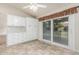Kitchen detail featuring white cabinets, marble countertops, tile flooring, and sliding door to patio at 4620 E Desert Cactus St, Phoenix, AZ 85032