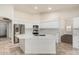 Bright kitchen with stainless steel appliances, white cabinetry, and center island featuring a marble countertop at 4620 E Desert Cactus St, Phoenix, AZ 85032