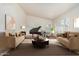Bright living room features a grand piano, neutral color palette, and multiple windows at 4620 E Desert Cactus St, Phoenix, AZ 85032
