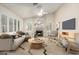 Comfortable living room with fireplace, stylish furniture, and lots of natural light at 4620 E Desert Cactus St, Phoenix, AZ 85032