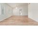Spacious living room featuring vaulted ceiling, fan, plantation shutters and modern wood-look flooring at 4620 E Desert Cactus St, Phoenix, AZ 85032