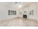 Spacious living room with a fireplace, tile flooring, and plantation shutters at 4620 E Desert Cactus St, Phoenix, AZ 85032