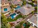 Aerial view of a home with a putting green, pool and spa, fire pit, and outdoor living area at 4865 S Cylinder Way, Mesa, AZ 85212
