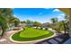 Sprawling backyard with a custom putting green, firepit, pool, and outdoor lounge area for entertaining at 4865 S Cylinder Way, Mesa, AZ 85212