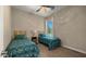 Bedroom with two twin beds, a ceiling fan, and a window with a view of the outside at 4865 S Cylinder Way, Mesa, AZ 85212