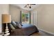 Bedroom with a bed, a ceiling fan, and a window with a view of the outside at 4865 S Cylinder Way, Mesa, AZ 85212