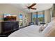 Bright bedroom with a ceiling fan, tv, seating area, and access to the outdoor space at 4865 S Cylinder Way, Mesa, AZ 85212