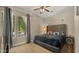 Bedroom with a large bed, a ceiling fan, and a window with a view of the outside at 4865 S Cylinder Way, Mesa, AZ 85212