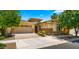 Charming two-story home with a well-manicured lawn, brick accents, and a two-car garage at 4865 S Cylinder Way, Mesa, AZ 85212