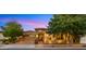 Charming home exterior featuring a brick facade, manicured landscaping, and a welcoming entrance at 4865 S Cylinder Way, Mesa, AZ 85212