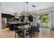 Bright, open kitchen and dining area with stainless appliances and outdoor access at 4865 S Cylinder Way, Mesa, AZ 85212