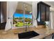 Kitchen sink view overlooks putting green, pool and outdoor entertainment area at 4865 S Cylinder Way, Mesa, AZ 85212