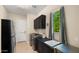 Well-lit laundry room with stainless steel appliances, ample counter space, storage cabinets, and a bright window at 4865 S Cylinder Way, Mesa, AZ 85212