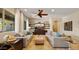 Comfortable living room with ceiling fan, tile floors, and plush sofas at 4865 S Cylinder Way, Mesa, AZ 85212