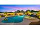 Inviting backyard pool and spa with palm trees, lounge chairs, and stylish lighting for evening enjoyment at 4865 S Cylinder Way, Mesa, AZ 85212