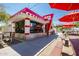 Charming outdoor eatery with picnic tables, red umbrellas, and a vintage-style building at 4865 S Cylinder Way, Mesa, AZ 85212