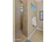 Walk-in shower with tiled walls and floors featuring a small glass block window at 4865 S Cylinder Way, Mesa, AZ 85212