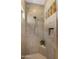 Tiled shower with a rainfall shower head, built-in seating, and a niche for storage at 4865 S Cylinder Way, Mesa, AZ 85212