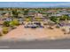 Aerial view of home with circular driveway, solar panels and desert landscaping at 6502 E Rustic Dr, Mesa, AZ 85215