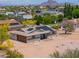 Aerial view featuring home with solar panels, circular driveway and desert landscaping at 6502 E Rustic Dr, Mesa, AZ 85215