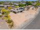 Aerial view of home highlighting desert landscaping,solar panels and circular driveway at 6502 E Rustic Dr, Mesa, AZ 85215