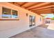 Covered patio area with views of the expansive backyard and house exterior at 6502 E Rustic Dr, Mesa, AZ 85215