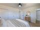 Bright bedroom featuring a ceiling fan, closet, and a modern vanity at 6502 E Rustic Dr, Mesa, AZ 85215