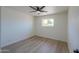 Cozy bedroom with neutral walls and light-colored floors has a bright window at 6502 E Rustic Dr, Mesa, AZ 85215