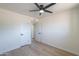 Bright bedroom features a ceiling fan and neutral paint with light wood flooring at 6502 E Rustic Dr, Mesa, AZ 85215