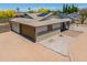 Home exterior featuring solar panels, garage, and desert landscaping at 6502 E Rustic Dr, Mesa, AZ 85215