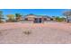 Inviting single-story home with desert landscaping and circular driveway, perfect for easy access and curb appeal at 6502 E Rustic Dr, Mesa, AZ 85215