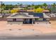 Charming single-story home featuring desert landscaping, solar panels, and a cozy front patio at 6502 E Rustic Dr, Mesa, AZ 85215