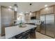 Modern kitchen with quartz island, stainless steel appliances, and warm wood cabinetry at 6502 E Rustic Dr, Mesa, AZ 85215