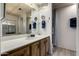 Bathroom featuring a single sink vanity with wood cabinets, mirrors and a walk-in shower at 661 S Hawes Rd # 81, Mesa, AZ 85208