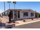 Inviting home with desert landscaping, covered carport, and bright exterior paint scheme at 661 S Hawes Rd # 81, Mesa, AZ 85208