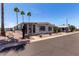 Charming single-story home featuring desert landscaping, a covered carport, and sunny skies at 661 S Hawes Rd # 81, Mesa, AZ 85208