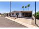 Charming single-story home with a covered carport and nicely manicured desert landscaping at 661 S Hawes Rd # 81, Mesa, AZ 85208