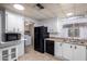 Well-organized kitchen with white cabinets, tile flooring, and modern appliances at 661 S Hawes Rd # 81, Mesa, AZ 85208