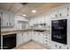 Practical kitchen showcasing white cabinets, tile floors, and essential appliances at 661 S Hawes Rd # 81, Mesa, AZ 85208