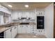 Efficient kitchen featuring white cabinets, appliances, and a practical layout at 661 S Hawes Rd # 81, Mesa, AZ 85208