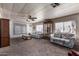 Cozy living room offering plenty of natural light, comfortable seating, and a display cabinet at 661 S Hawes Rd # 81, Mesa, AZ 85208