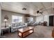 Comfortable living room with floral-patterned sofas, a glass-top coffee table, and a large window at 661 S Hawes Rd # 81, Mesa, AZ 85208