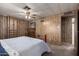 Comfortable main bedroom with wood-paneled walls, offering generous storage in built-in closets at 661 S Hawes Rd # 81, Mesa, AZ 85208